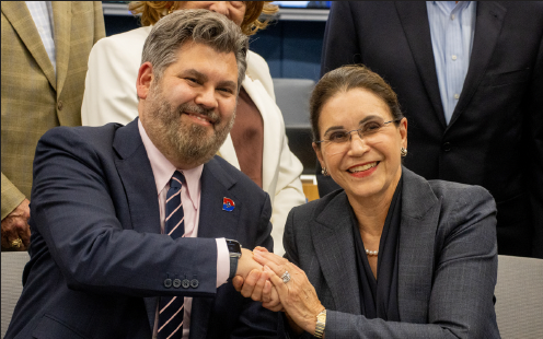 TCC Chancellor Elva LeBlanc and Dallas College Chancellor Justin Lonon shake hands after signing the agreement.